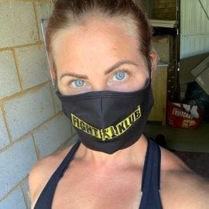 A blonde girl with blue eyes wearing a black branded Fight Klub facemask